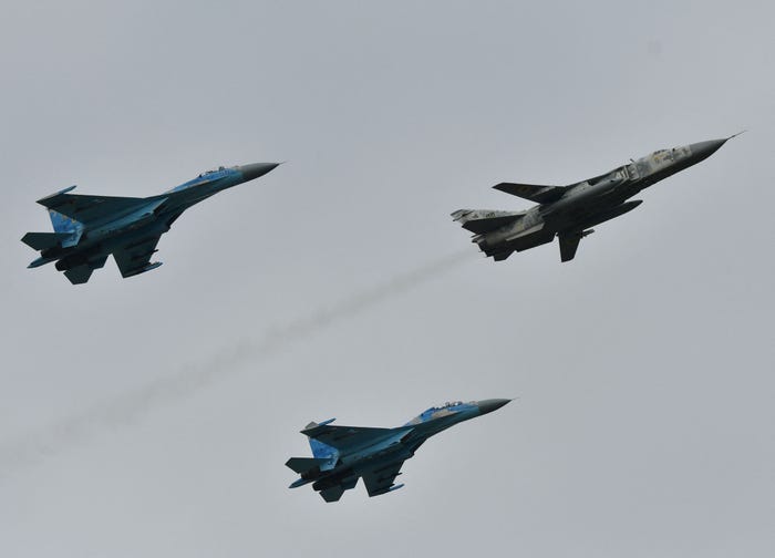Ukrainian SU-27 fighters escort an SU-24 front-line bomber during an air force exercises on Starokostyantyniv military airbase on October 12, 2018.
