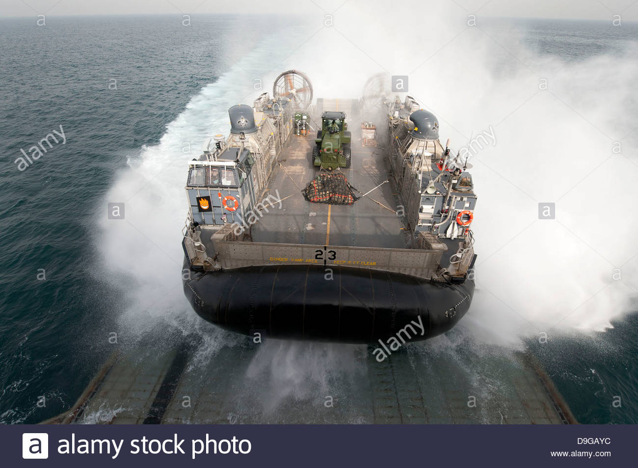 a-landing-craft-air-cushion-enters-the-well-deck-of-uss-pearl-harbor-D9GAYC.jpg