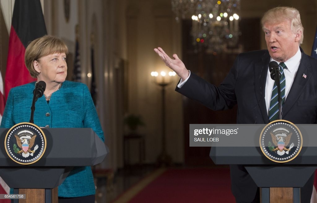 president-donald-trump-and-german-chancellor-angela-merkel-hold-a-picture-id654561758
