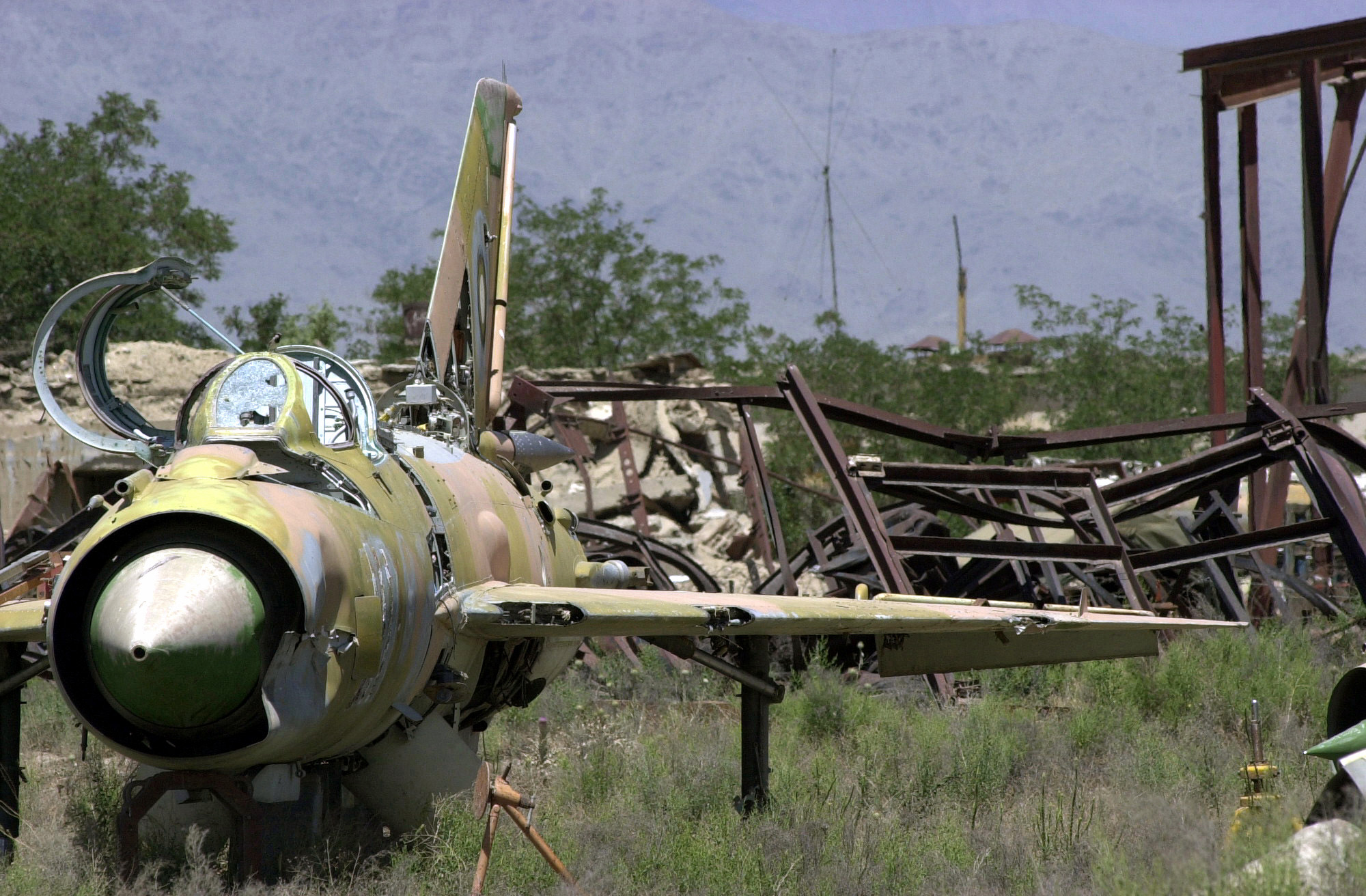 The_wreckage_of_an_abandoned_Soviet_Mig-21_Fishbed_aircraft_sits_with_rusted_hardware_in_an_open_field_near_Bagram_Air_Base,_Afghanistan.JPEG