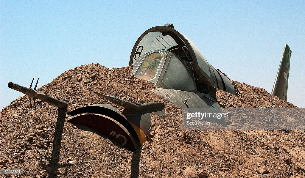 an-iraqi-air-force-mig-fighter-jet-is-buried-in-the-sand-near-the-picture-id72483791