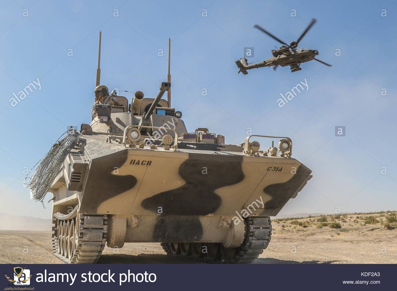 a-us-army-ah-64-apache-attack-helicopter-flies-over-a-opposing-force-KDF2A3.jpg