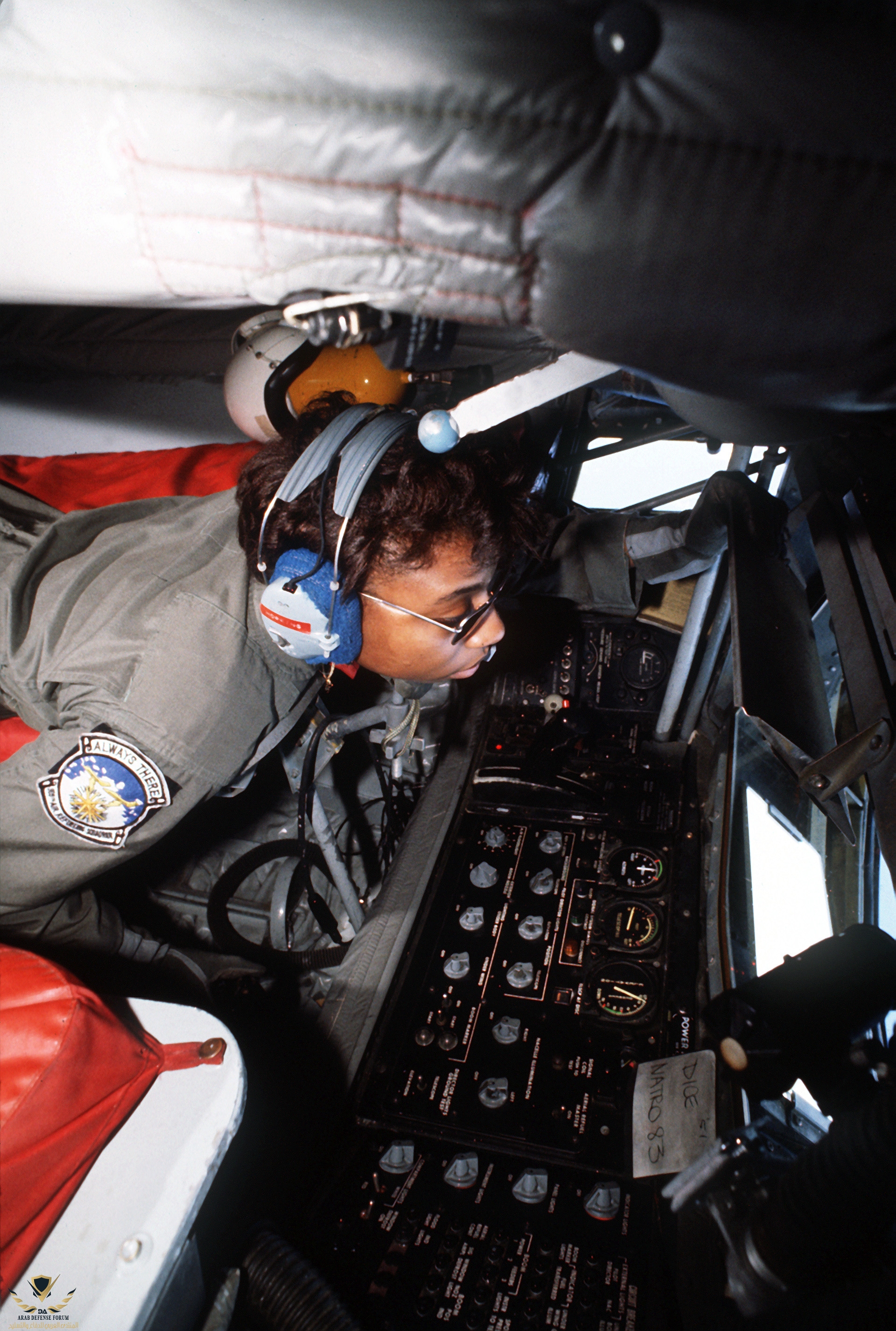 An_aerial_refueling_boom_operator_looks_out_the_observation_window_of_a_KC-135_Stratotanker_ai...jpg