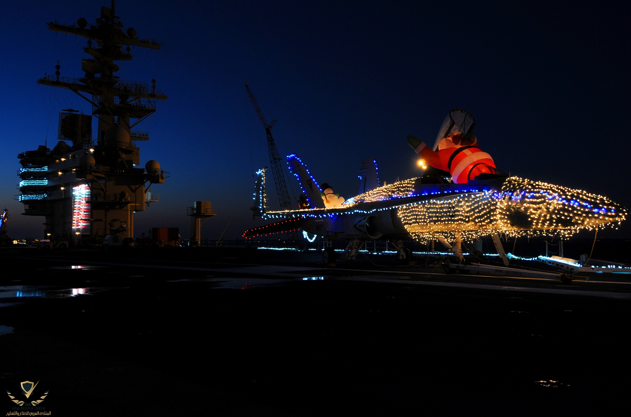 US_Navy_101219-N-6632S-012_An_F-A-18_Hornet_is_decorated_with_Christmas_lights_on_the_flight_d...jpg