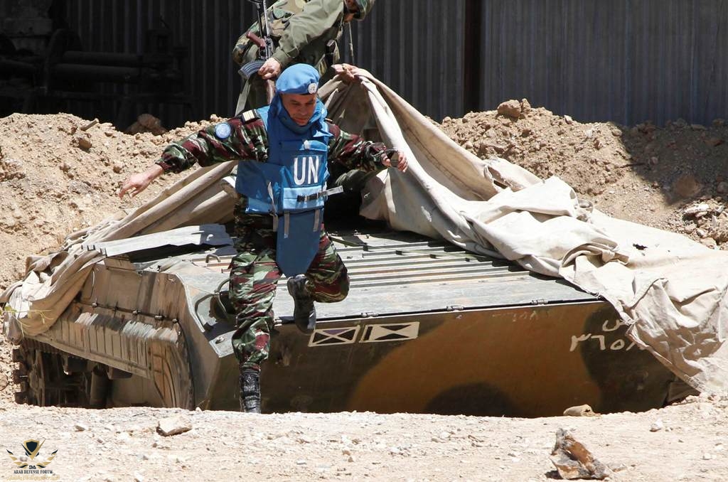 a-moroccan-colonel-leader-of-the-u-n-monitoring-team-jumps-from-a-syrian-army-bmp-1-during-a-f...jpg