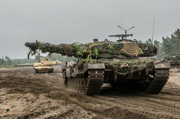 US Army M1A2 Abrams MBTs alongside Polish Leopard IIA4 MBTs.png