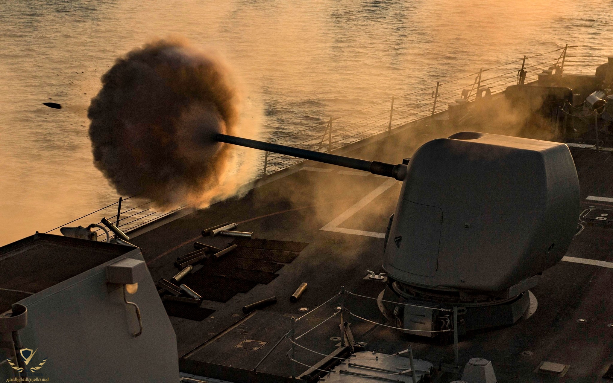 The Arleigh Burke-class guided missile destroyer USS Carney DDG 64 fires its 5inch gun during ...jpg
