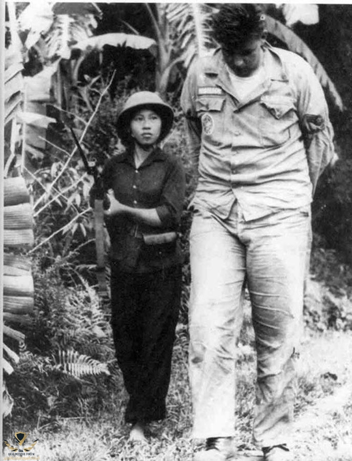 The longest Surviving POW in Vietnam William Andrew Robinson being held by an armed NVA guard...jpeg