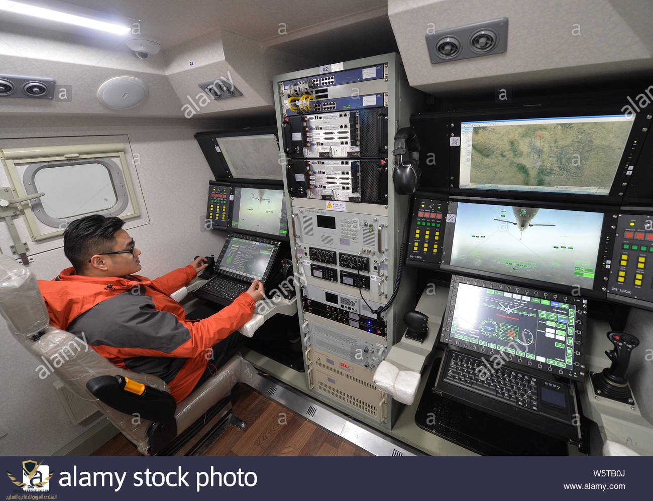 file-a-chinese-worker-tests-the-operation-and-control-system-for-the-wing-loong-unmanned-aeria...jpg