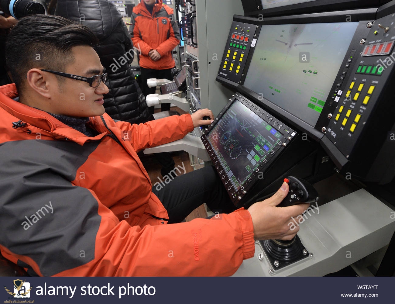 file-a-chinese-worker-tests-the-operation-and-control-system-for-the-wing-loong-unmanned-aeria...jpg