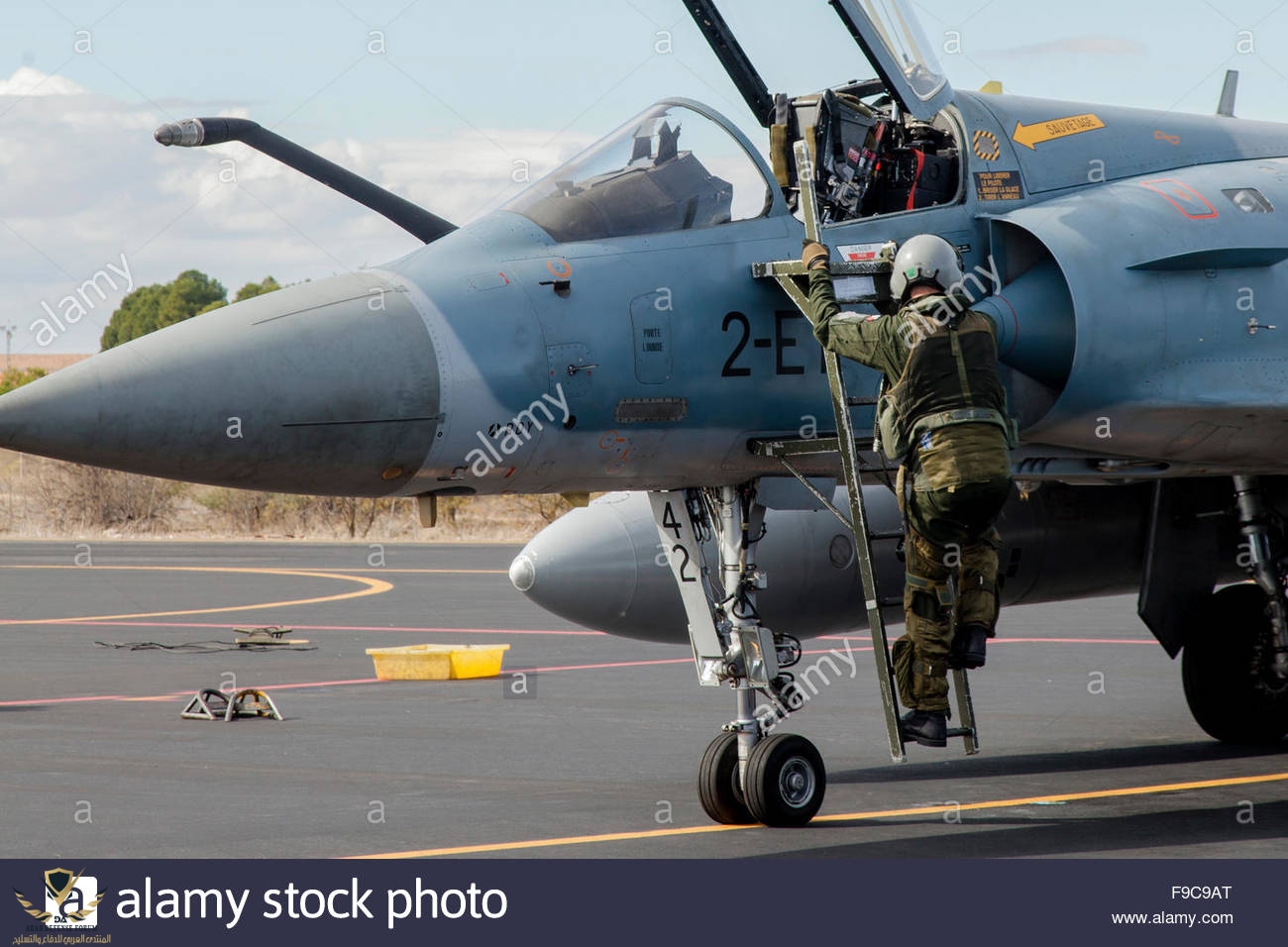 a-pilot-climbs-into-the-cockpit-of-a-french-air-force-mirage-2000-F9C9AT.jpg