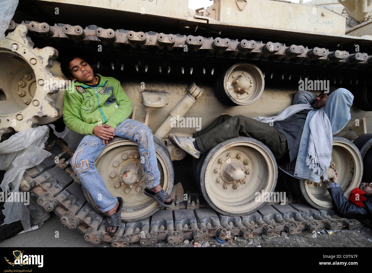 anti-mubarak-protesters-sleeping-between-the-wheels-of-an-egyptian-C0TN7F.jpg