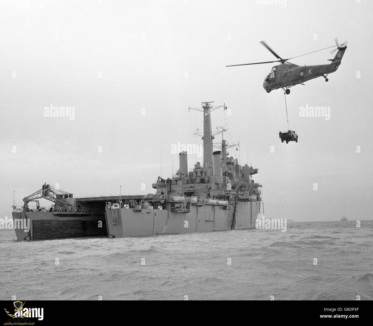 a-royal-air-force-helicopter-carrying-an-army-land-rover-moves-in-G8DP3F.jpg