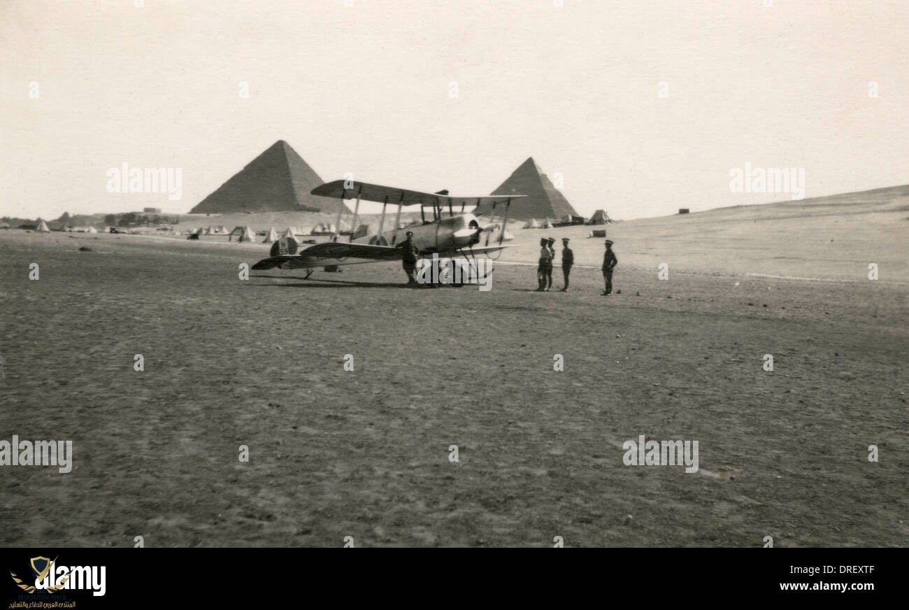 a-biplane-in-the-egyptian-desert-with-the-pyramids-DREXTF.jpg
