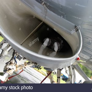 pilot-inspecting-jet-air-intake-on-f16-fighter-plane-A0E1T8.jpg