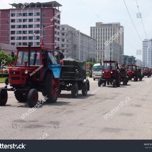 stock-photo-military-tractors-parade-in-front-of-waving-crowds-through-the-streets-of-pyongyan...jpg