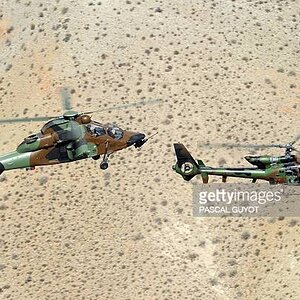 a-french-army-eurocopter-tiger-attack-helicopter-and-a-gazelle-reconnaisance-helicopter-fly.jpg