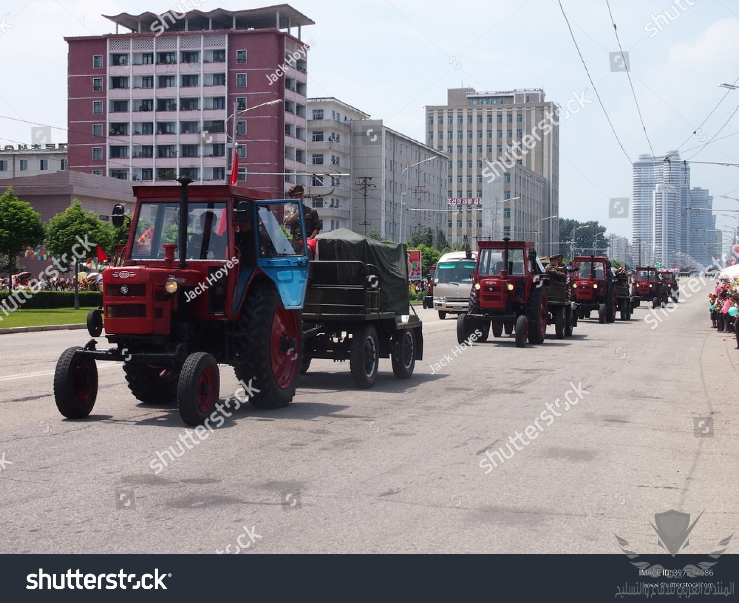 stock-photo-military-tractors-parade-in-front-of-waving-crowds-through-the-streets-of-pyongyan...jpg