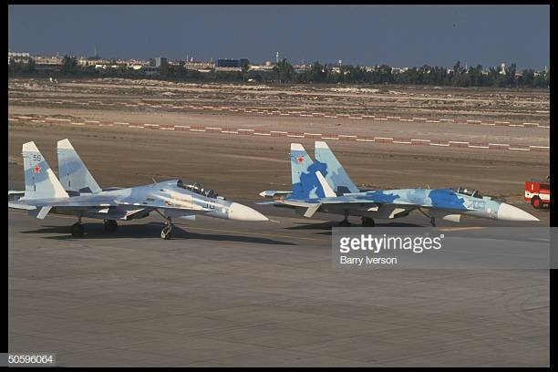 prob-russianmade-sukhoi-jet-fighter-planes-on-tarmac-among-mil-arms-picture-id50596064