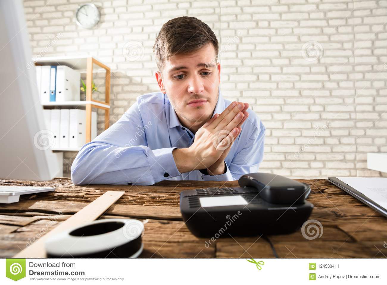 businessman-waiting-call-telephone-portrait-young-wooden-desk-124533411.jpg