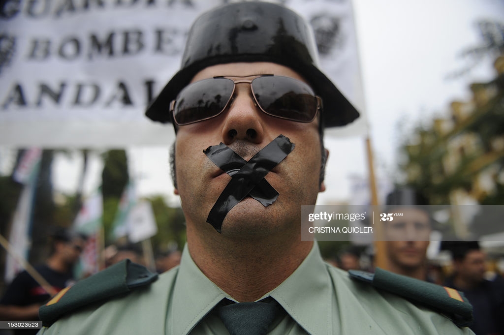 spanish-civil-guard-with-his-mouth-sealed-with-tape-attends-a-of-picture-id153023523