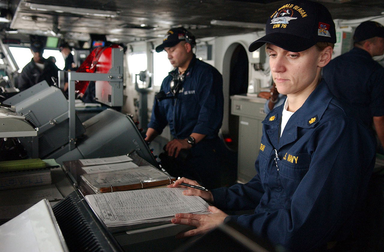 1280px-US_Navy_060409-N-4776G-027_Lt._Cmdr._Karen_Sray,_watches_a_tracking_monitor_while_standing_the_junior_officer_of_the_deck_(JOOD)_watch_on_the_bridge_of_the_Nimitz-class_aircraft_carrier_USS_Ronald_Reagan_(CVN_76).jpg