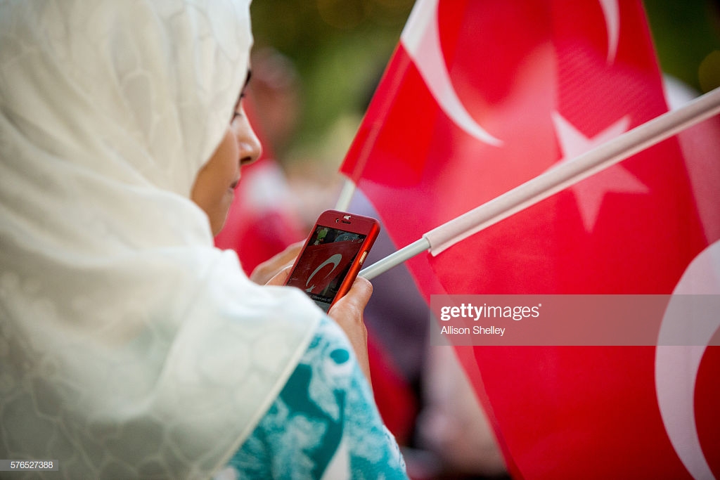 woman-prepares-to-send-a-photo-of-the-turkish-flag-out-over-social-picture-id576527388