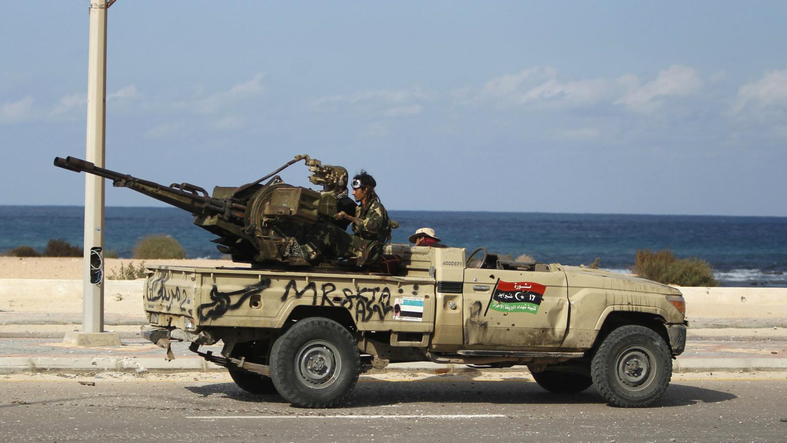 anti-gaddafi-fighters-fire-an-anti-aircraft-heavy-machine-gun-mounted-on-the-back-of-a-pickup-truck-in-2011.jpg