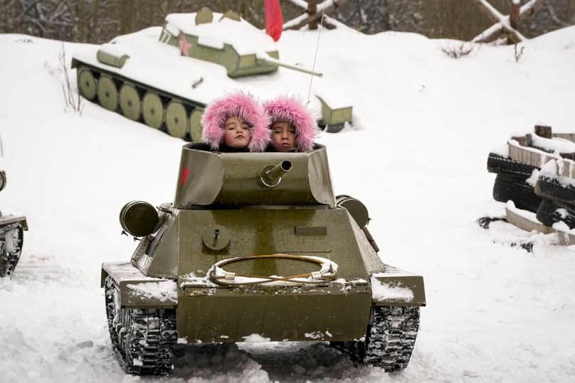 أطفال يركبون نموذجًا لدبابة سوفييتية من طراز T-34 من حقبة الحرب العالمية الثانية خلال مهرجان تاريخي عسكري قرب سانت بطرسبرغ