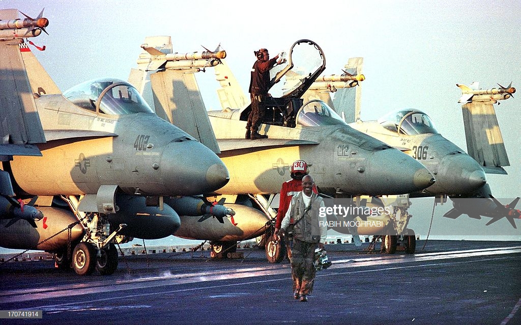 navy-f18-hornet-fighter-planes-are-readied-on-the-flight-deck-of-the-picture-id170741914