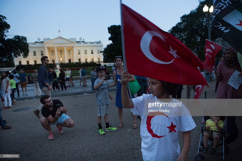 girl-holds-a-turkish-flag-as-a-group-gathers-in-front-of-the-white-picture-id576527410