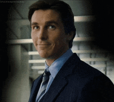 bruce wayne smirk GIF