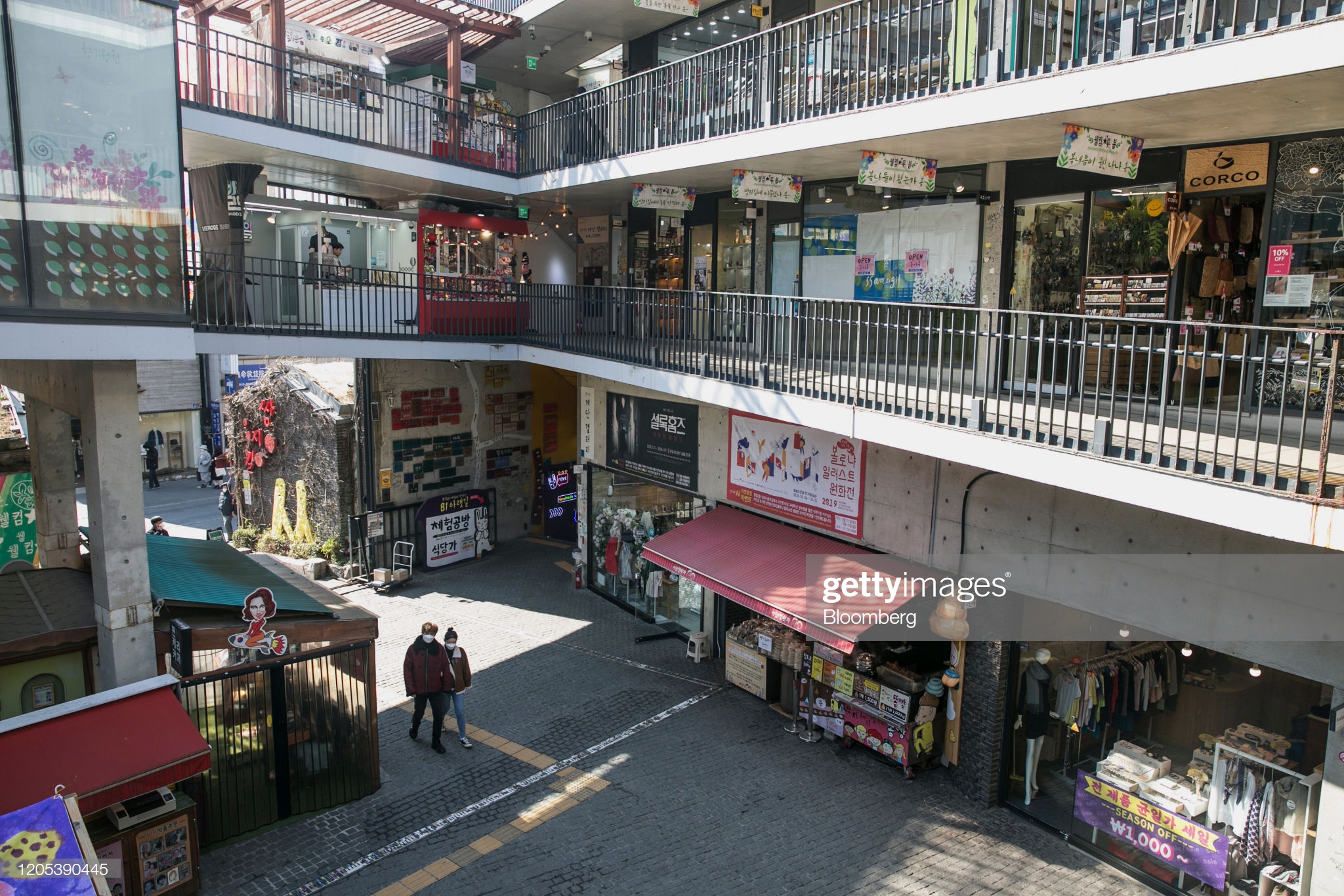visitors-walk-inside-a-shopping-mall-in-the-insadong-neighborhood-in-picture-id1205390445