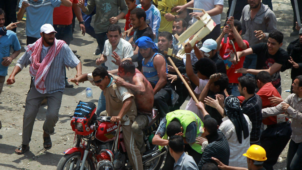 120502214404_egyptian_protesters_beat_a_man_as_he_tries_to_escape_on_the_back_of_a_motorcycle__976x549_afp_nocredit.jpg