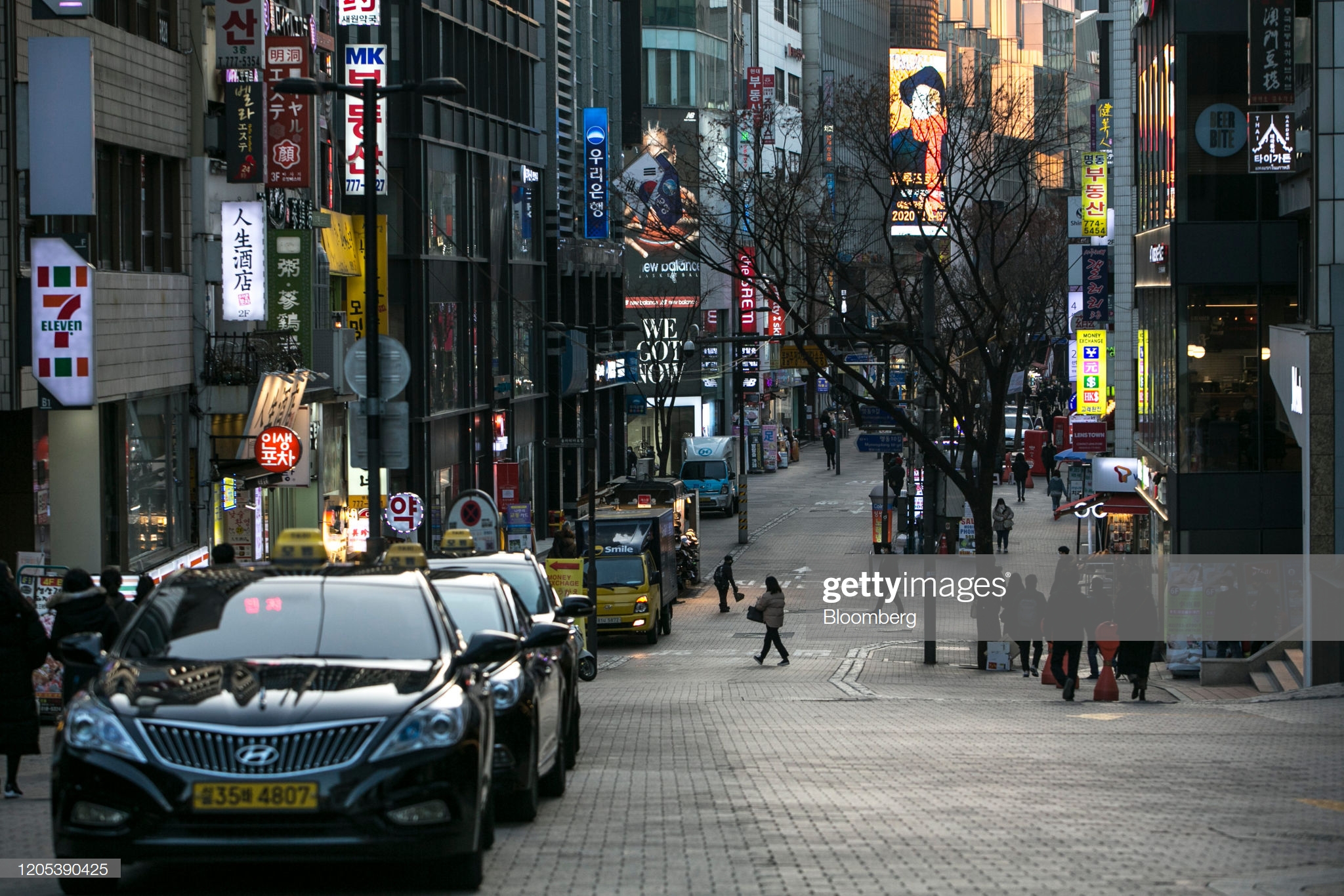 vehicles-sit-parked-on-a-street-in-the-myeongdong-district-in-seoul-picture-id1205390425