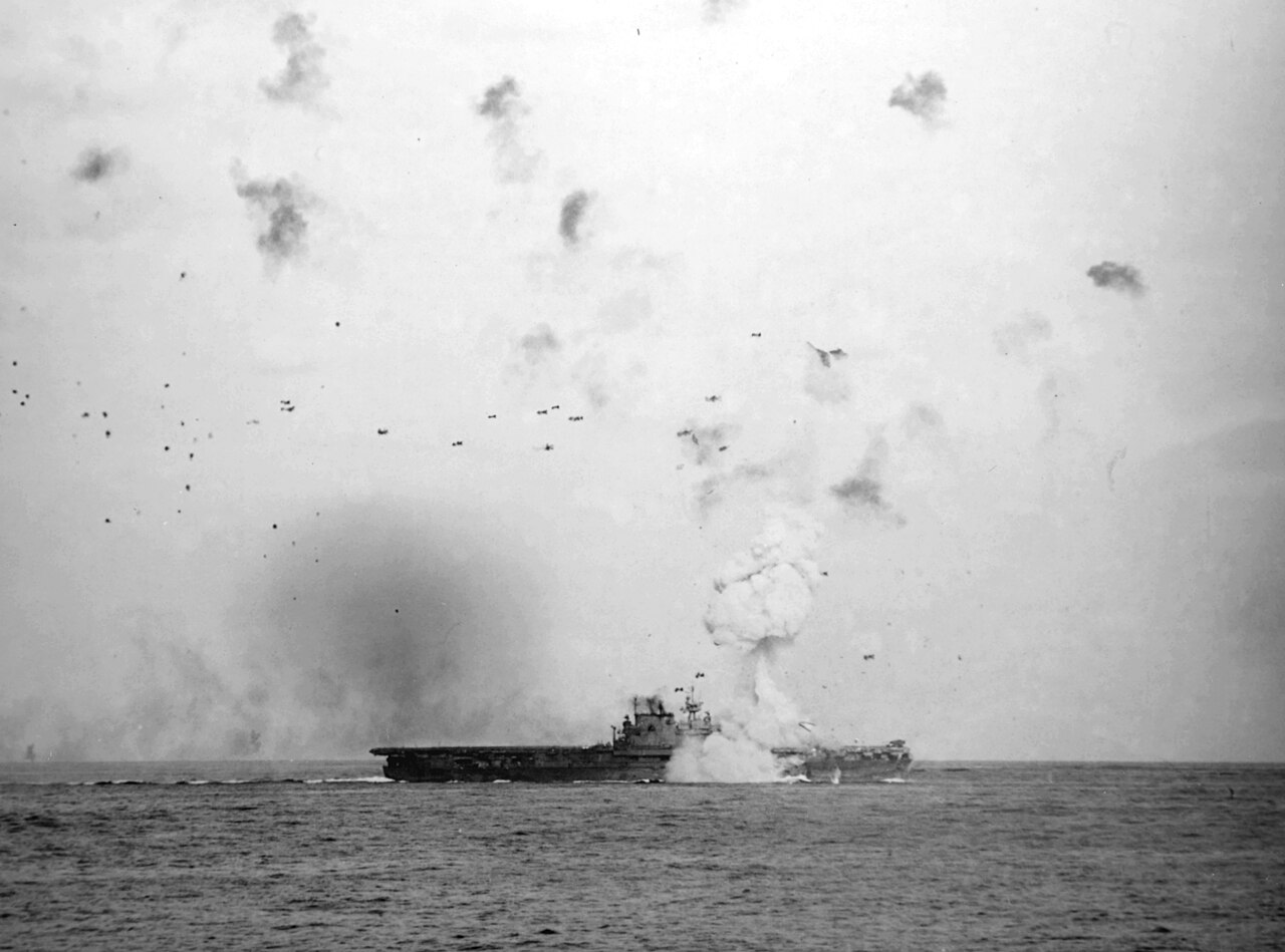 1280px-USS_Enterprise_%28CV-6%29_is_hit_by_kamikaze_on_14_May_1945_%2880-G-323565%29.jpg