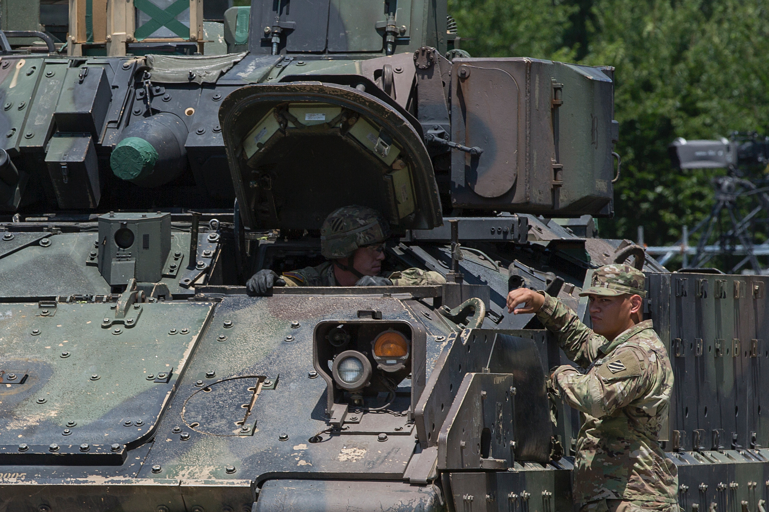A member of the US military (L) inside a Bradley Fighting Vehicle speaks with another member on July 3, 2019 ahead of the Salute to America at the Lincoln Memorial on the National Mall in Washington, DC.