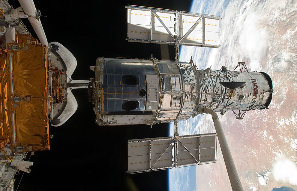 The-Hubble-Space-Telescope-lifted-out-of-the-payload-bay-of-Atlantis-moments-before-it-is-released-into-space-following-the-successful-repair-mission-of-STS-125.jpg