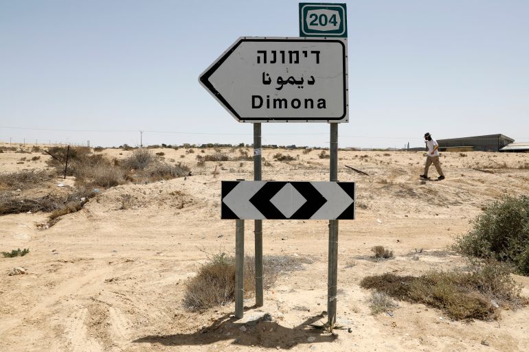 This picture taken on April 22, 2021 shows a view of a road sign directing towards the city of Dimona, close to the nuclear power plant in the southern Israeli Negev desert. (Photo by Ahmad GHARABLI / AFP)