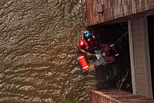220px-United_States_Coast_Guard_Scott_D._Rady_pulls_a_pregnant_woman_from_her_flooded_New_Orleans_home.jpg