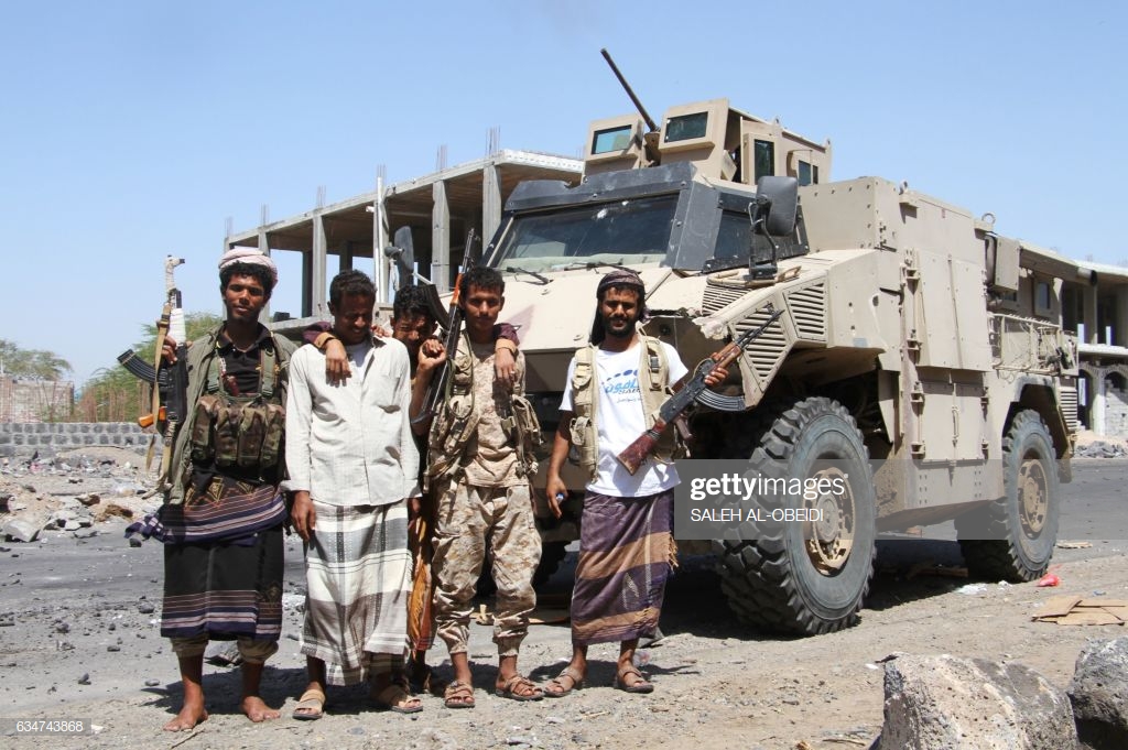 fighters-loyal-to-the-saudibacked-yemeni-president-pose-in-front-of-picture-id634743868