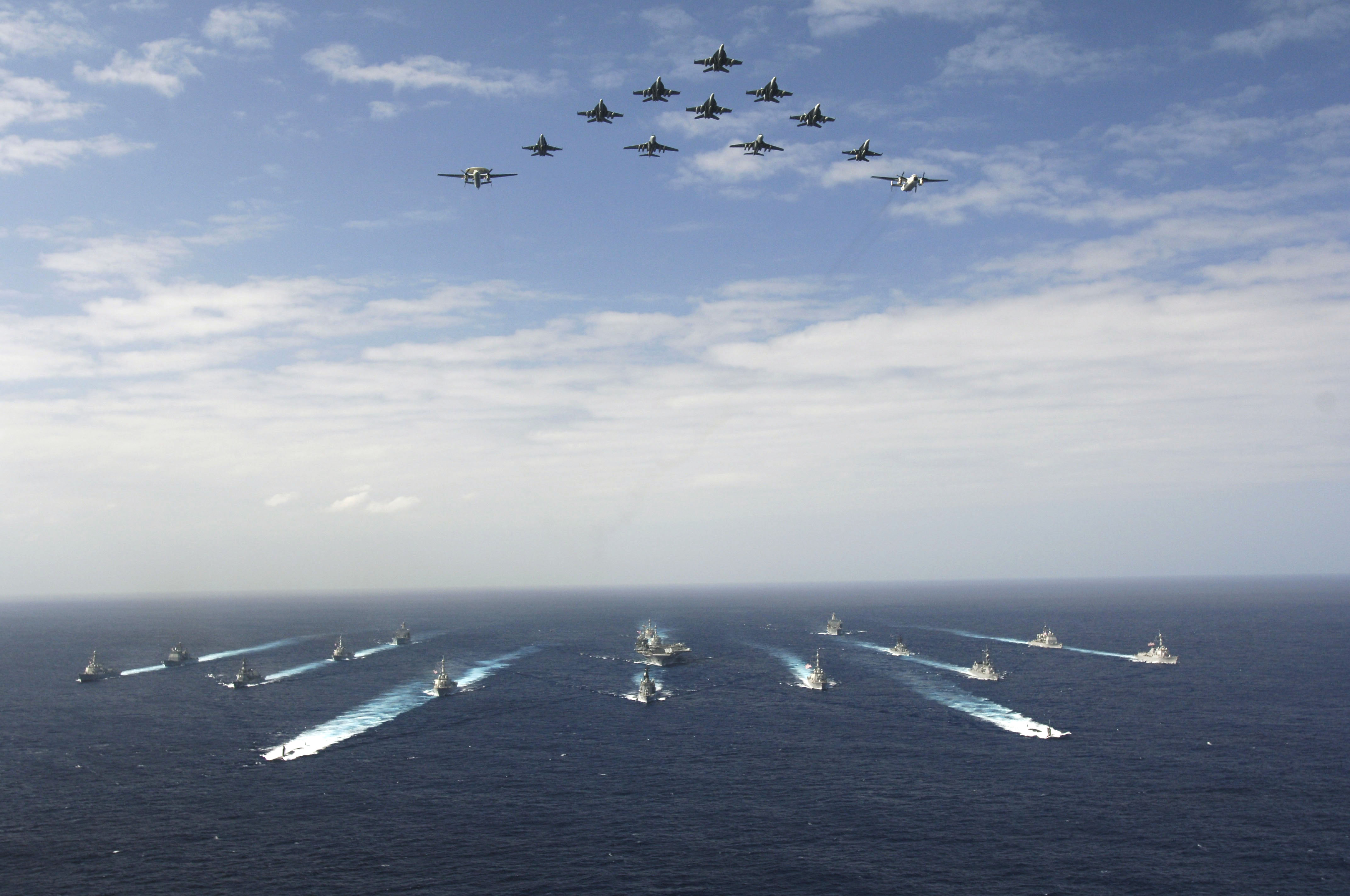 US_Navy_061114-N-8591H-147_Aircraft_assigned_to_Carrier_Air_Wing_Five_(CVW-5)_fly_over_a_group_of_18_U.S._and_Japanese_Maritime_Self-Defense_Force_ships,_at_the_conclusion_the_two_nations'_exercise_ANNUALEX.jpg