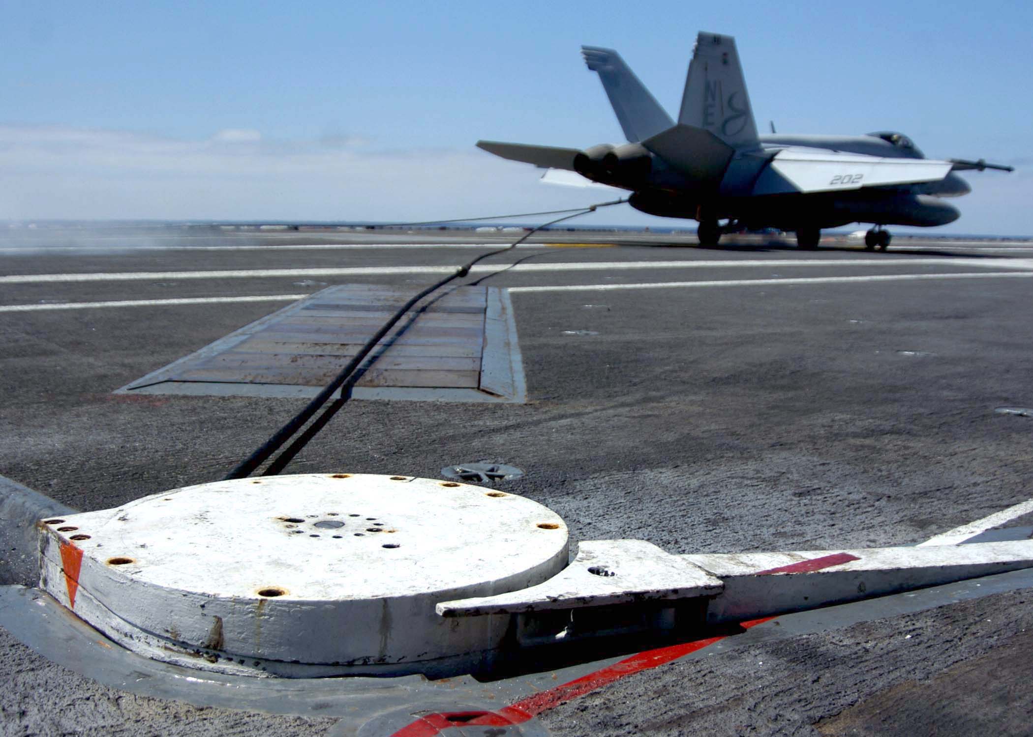 US_Navy_050913-N-5384B-337_An_F-A-18_Hornet_catches_the_arresting_gear_wire_on_the_flight_deck_aboard_the_Nimitz-class_Carrier_USS_Abraham_Lincoln_(CVN_72).jpg