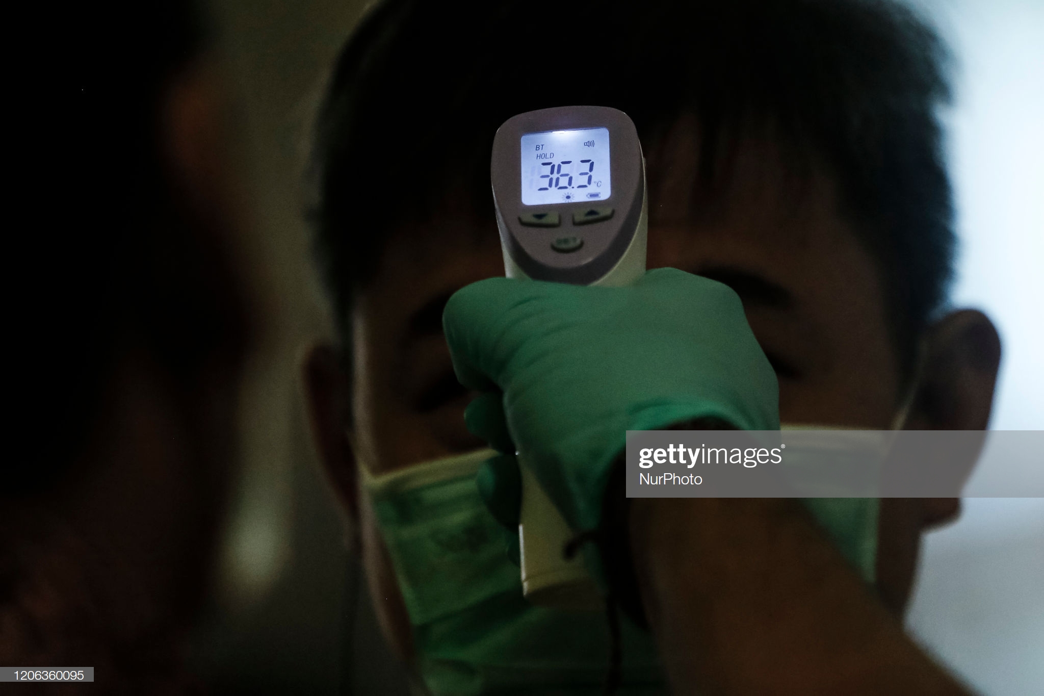 health-officer-checks-body-temperature-on-a-domestic-flight-passenger-picture-id1206360095