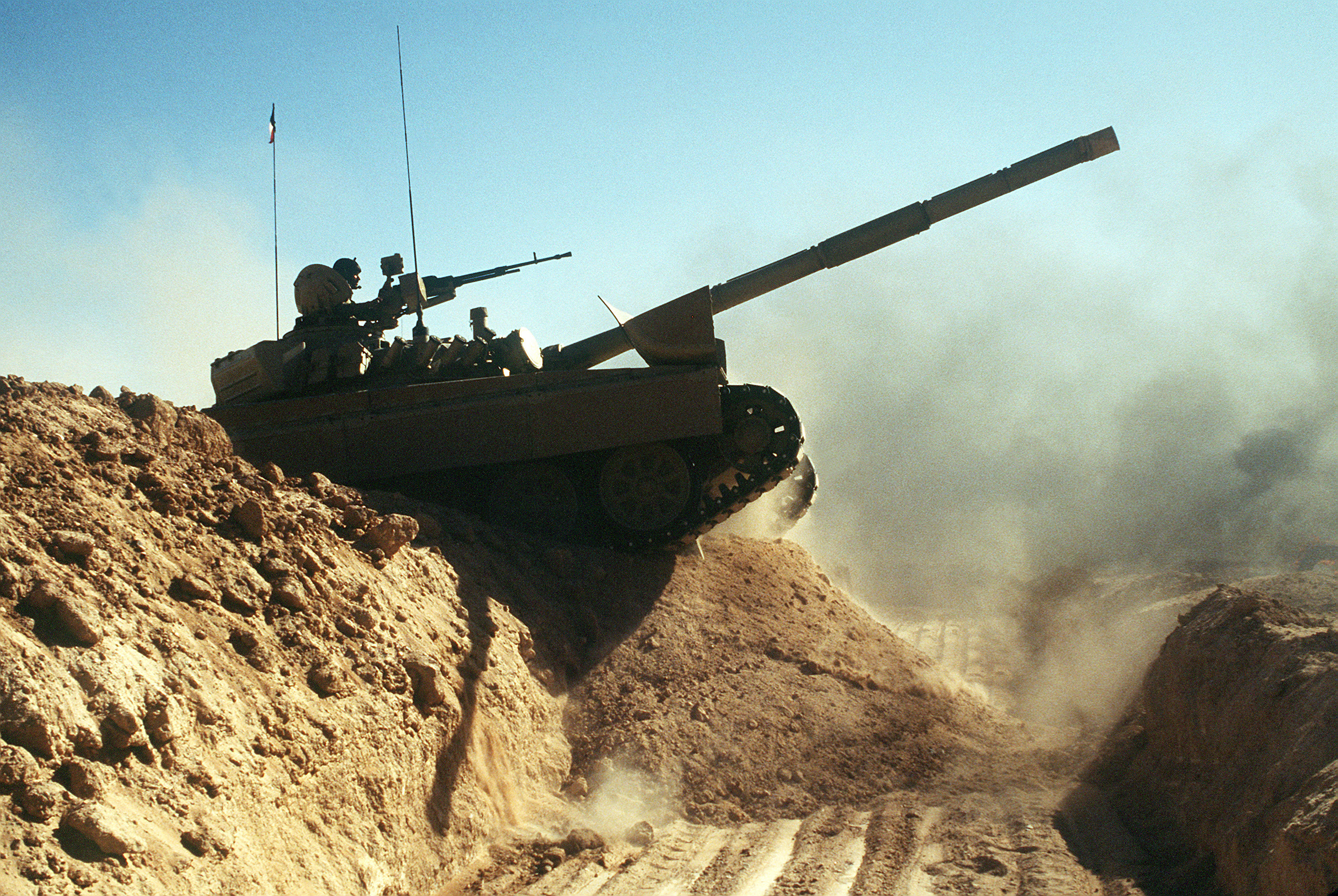A_Kuwaiti_M-84AB_tank_crosses_a_trench_during_Operation_Desert_Shield.JPEG