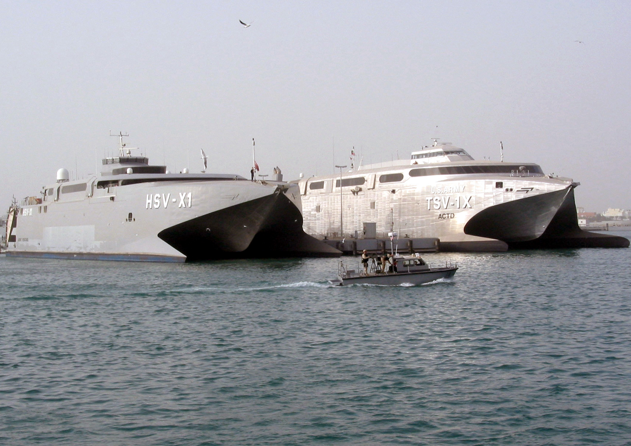 US_Navy_030225-N-1050K-001_Sealift_vehicles_belonging_to_the_U.S._Navy_and_U.S._Army_sit_together_pier_side_under_the_watchful_eye_of_both_the_U.S._and_Kuwaiti_harbor_patrol.jpg