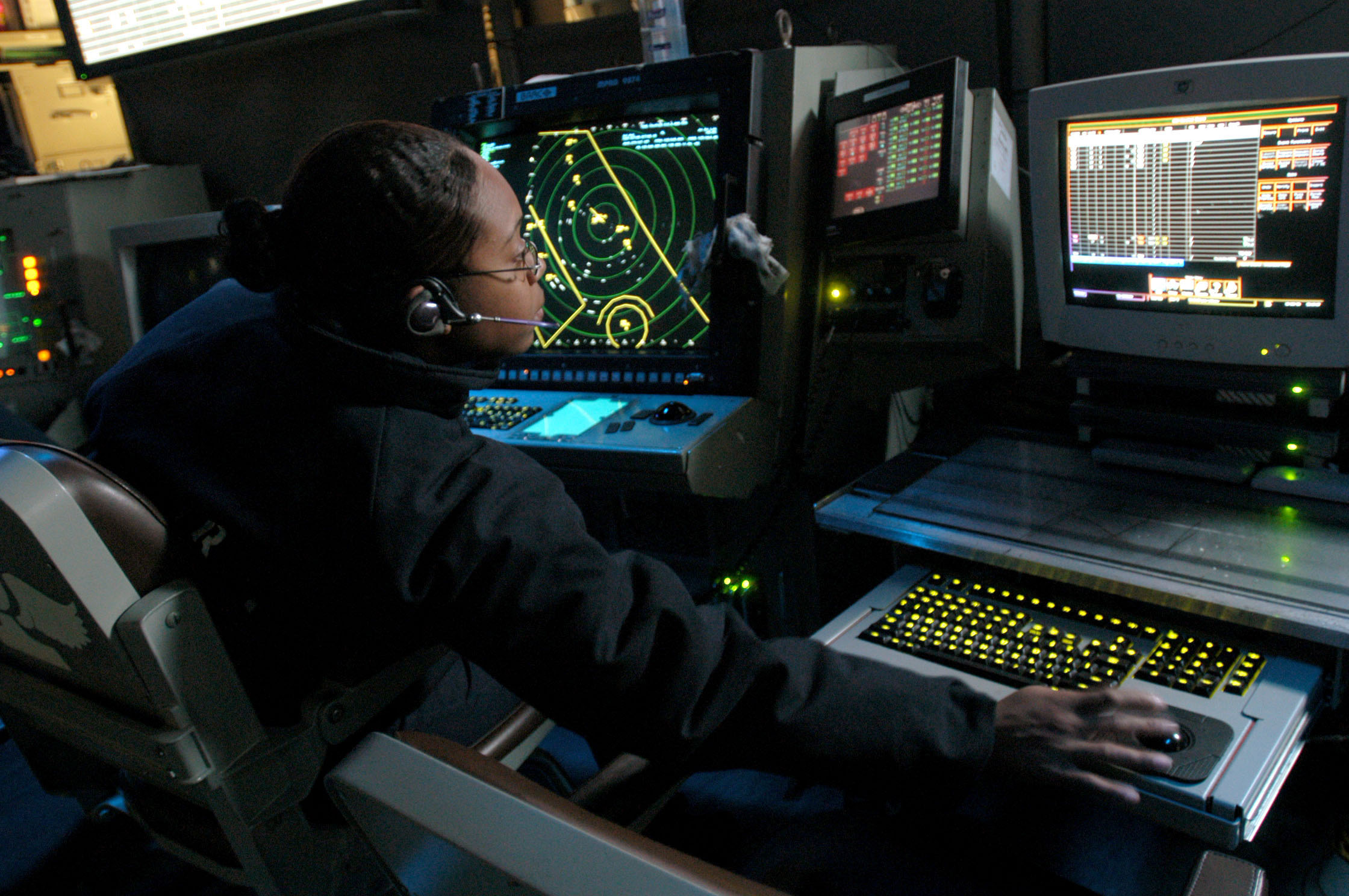 US_Navy_051118-N-9805F-506_Air_Traffic_Controller_2nd_Class_Petty_Officer_Alisa_Barnes_of_Mobile,_Ala.,_monitors_both_the_Approach_A_and_Approach_ISIS_consoles_in_the_Carrier_Air_Traffic_Control_Center_(CATCC)_aboard_USS_Theodo.jpg