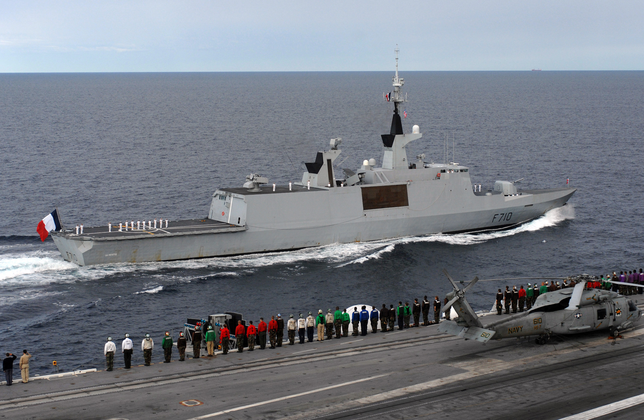 US_Navy_070704-N-2984R-002_Sailors_aboard_Nimitz-class_aircraft_carrier_USS_Harry_S._Truman_(CVN_75)_render_honors_to_French_frigate_La_Fayette_(F-710).jpg