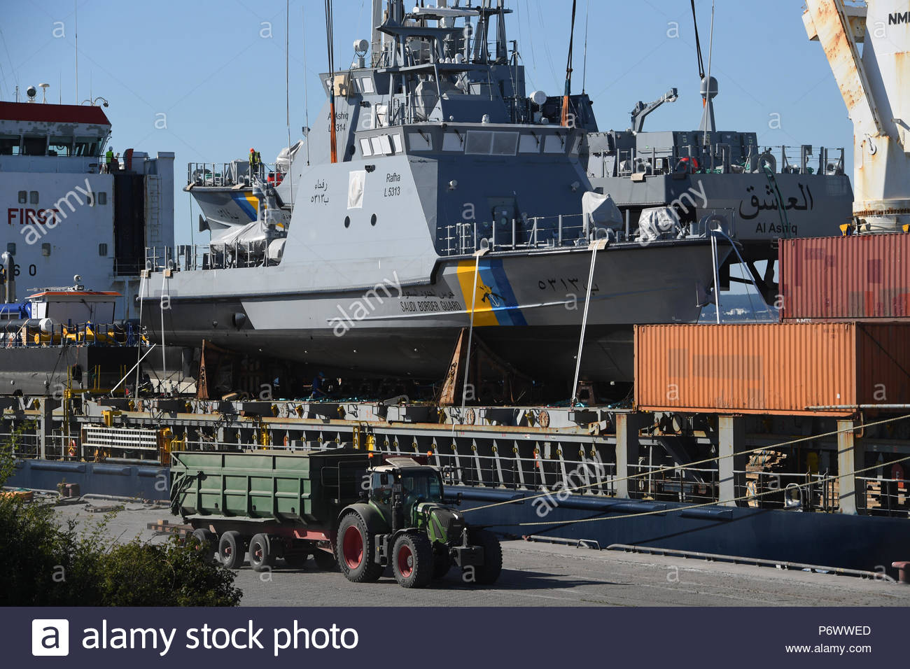 sassnitz-germany-03rd-july-2018-a-coast-guard-boat-for-saudi-arabia-being-loaded-on-a-transport-ship-in-the-port-of-mukran-the-luerssen-group-from-bremen-owner-of-the-wolgaster-shipyards-received-an-order-valued-in-the-billions-of-euros-for-the-construction-of-a-fleet-of-new-patrol-boats-for-saudi-arabia-and-began-with-construction-works-in-2015-only-in-march-this-year-however-did-the-federal-government-approved-the-delivery-to-the-kingdom-of-8-further-ships-around-300-workers-are-employed-by-the-wolgaster-luerssen-shipyards-credit-stefan-sauerdpa-zentralbilddpaalamy-live-news-P6WWED.jpg