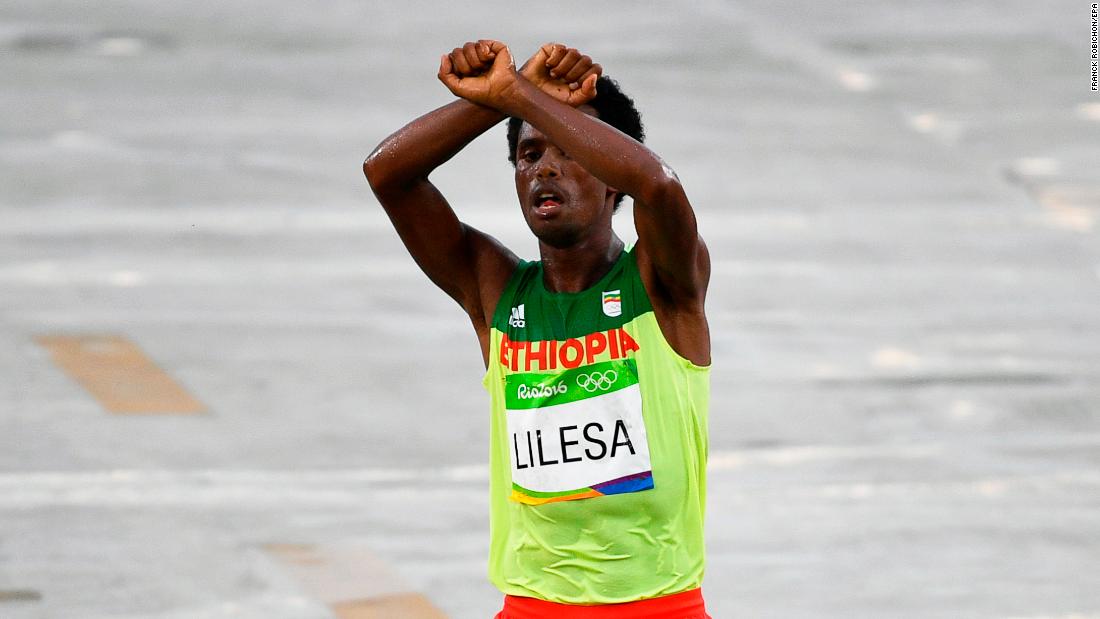 Feyisa Lilesa protests as he takes second place in the men's marathon race at the Rio 2016 Olympic Games. Feyisa Lilesa protests as he takes second place in the men's marathon race at the Rio 2016 Olympic Games.